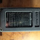 Spodní strana šedého efektpedálu značky BOSS. Na černé štítku je uveden nápis AC ADAPTOR a seznam kompatibilních adaptérů ACA-100, ACA-120, ACA-220 a…