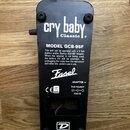 Spodní strana černého efekt pedálu s nápisem cry baby classic. Na povrchu je uveden MODEL GCB-95F, značka Fasel a logo DUNLOP. Jsou zde rovněž instru…