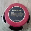 Reproduktor s růžovým magnetem a šedým kovovým rámem. Na štítku je uveden nápis CELESTION a detaily: Model G12 H, Power capacity 150 WATTS, Impedance…