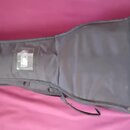 Černý polstrovatý pouzdro (gig bag) na kytaru. Na pravé straně je bílý nápis Fender. Pouzdro má v horní části průhlednou kapsu na dokumenty a spodní…