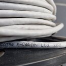 Bílý svazkový kabel smotaný do klubíčku. Na povrchu je černý nápis CAT5e E-Cable, Ltd. J3711. Kabel vykazuje mírné znečištění povrchu.