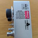 Stříbrný kovový efekt pedál s černým ovládacím knoflíkem. Na boku je tabulka s nápisy SRV MOD, VINTAGE TS, AMP-LIKE, CLASSIC, ASYM-CLIP, SYMMETRIC, O…