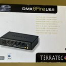 Krabice s produktem DMX6Fire USB od značky TERRATEC. Na obalu je fotografie černého externího audio rozhraní s nápisem TERRATEC na horní straně a DMX…