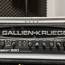 Kytarový zesilovač v hliníkovém kufru s nápisem GK GALLIEN-KRUEGER. Na předním panelu je modelové označení Fusion 550 a text Hybrid Valve Bass Amplif…