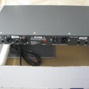 Šedý rackový audio procesor s nápisem elysia. Na zadním panelu jsou viditelné konektory XLR, přepínač DEMO a napájecí vstup. Je zde uveden text MADE…