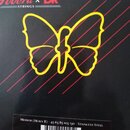 Černá krabička od strun s žlutým obrysem motýla a červenými šikmými čarami v pozadí. V horní části je nápis Fodera x DR STRINGS. Dole se nachází text…