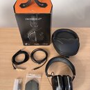 Na fotografii je sada sluchátek s příslušenstvím. Je zde černý papírový box s oranžovým vrchem a nápisy CROSSFADE LP2, milano design a vmoda. Součást…