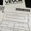 Fotografie zobrazuje dva papírové dokumenty. Horní list obsahuje logo VEVOR a nápis Upgrade · The Home Creator Way, v horním rohu je uveden S/N(Date…