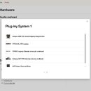 Snímek zachicuje screenshot uživatelského rozhraní webové stránky v sekci Hardware. V popředí je otevřené okno s názvem Plug-iny System 1, které obsa…