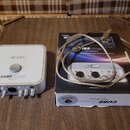 Bílá zvuková karta s logem icon a nápisem CUBE 4nano USB 2.0 High-Speed. Zařízení má na přední straně čtyři vstupní konektory a ovládací knoflíky. Ve…