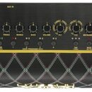 Černý kytarový zesilovač s nápisem Vox Adio Air GT. Horní ovládací panel obsahuje rotační přepínač s označením různých zvuků (např. TEXAS LEAD, BRIT…
