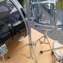 Černý basový buben a chromovaný malý buben na kovových stojanech. Na malém bubnu je čitelný nápis SWINGSTAR by TAMA a pod ním menší text MADE IN TAIW…