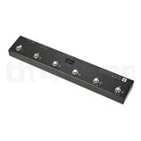Černý MIDI kontrolér v obdélníkovém kovovém šasi s nápisem CUSTOM USB MIDI CONTROL LIVE LOGIC a hvězdou. Zařízení má šest kovových spínačů označených…