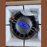 Černý kruhový reproduktor umístěný v polystyrenovém obalu. Na zadní straně je modrý štítek s bílým textem COMPRESSION DRIVER-SMC65/Nd, S.N. A785130,…