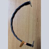 Černý audio kabel s pleteným obalem a konektory typu jack. Na spodním konektoru je hnědý kožený pásek s vyraženým nápisem sonorus a menším textem pod…