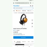 Snímek zachycuje černá uzavřená sluchátka s náušníky z hnědého dřeva s viditelnou strukturou zrn. Na stránce je uveden název modelu Audio-Technica AT…