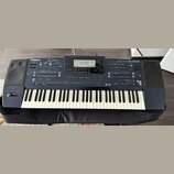Tmavě modrý digitální klavír značky Roland, model EM-2000. Na horním panelu jsou vidět nápisy Roland, EM-2000 a Creative Keyboard. Nástroj má standar…