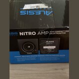 Fotografie zachycuje kartonovou krabici s produktem Alesis Nitro Amp. Na přední straně je nápis NITRO AMP 70W COMPACT PER DRUM MONITOR a obrázky dvou…
