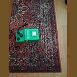 Zelený kytarový efekt pedál v kovovém provedení. Na horní části je nápis TUBE-SCREAMER a pod ním Overdrive Pro TS900B, vpravo je logo Ibanez. Pedál m…