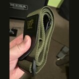 Zvolněný kytarový popruh v olivově zelené barvě z textního materiálu. Na černé kožené části je žlutý nápis ERNIE BALL. Popruh vykazuje mírné známky p…
