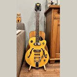 Žlutá polodupatá elektrická kytara s f-otvory a chromovaným hardwarem. Na hlavě je nápis "Epiphone" a na spodní části těla u mostu značka "Epiphone".…