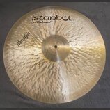 Kruhový mosazný činel s viditelným ručním klepaním povrchu. V horní části je černý nápis istanbul® a pod ním kurzívou Mehmet Handmade Cymbals from Tu…