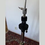 Detailní pohled na horní část chromovaného stojanu. Součástí je stahovací šroub s knoflíkem a dvě černé tlumicí vložky z pěnového materiálu. Na povrc…