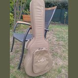 Hnědý polstrovaný obal na kytaru s úchytem a zipy. Na horní části je nápis GSmini, na přední kapse je logo Taylor obklopené nápisem QUALITY GUITARS.…