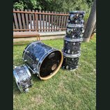 Sada bubnů s tmavým, mramorovaným povrchem v odstínech černé a šedé. Na rezonanční kože a na tomarech je viditelné logo „dw drums“. Sada obsahuje bas…