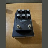 Černý efekt pedál s nápisy Dream a 65 REVERB-AMP. Obsahuje šest ovládacích knoflíků s popisky BASS, TREBLE a BOOST, tři přepínače a dva stisknuté spí…