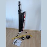 Černý keytar s bílým povrchem na pravém boku, který je zdoben červenými skvrnami připomínajícími krev. Na hmatníku je svisle napsáno AX-Edge a v doln…