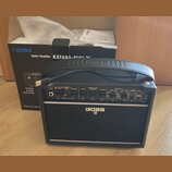 Černý kytarový kombozesilovač s rukojetí a logem BOSS. Na ovládacím panelu jsou nápisy INPUT, KATANA-MINI X, GAIN, TYPE, VOLUME, EQUALIZER BASS MIDDL…