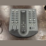 Šedý mixážní pult s nápisem MACKIE. U.420d. Zařízení obsahuje čtyři vstupní kanály s ovládacími knoflíky pro GAIN, EQ (HIGH, MID, LOW), AUX a LEVEL,…