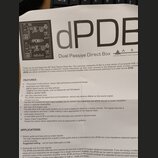 Fotografie zachycuje část uživatelské příručky k zařízení s názvem dPDB Dual Passive Direct Box. V horní části je vidět schéma zapojení a logo ART (A…