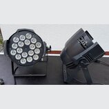Dvě černé světla na stojáncích. Levý přístroj je kulatý s 18 LED diodami v mřížce, pravý přístroj má kompaktní hranatý tvar s ventilačními otvory. Na…