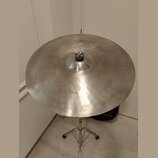 Stříbrný kovový činel umístěný na chromovaném stojanu. Na povrchu je viditelný nápis Zildjian a v horní části menší nápis K. Povrch vykazuje jemné šk…