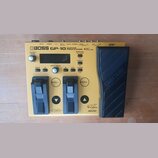 Žlutý kytarový procesor BOSS GP-10 GUITAR PROCESSOR s černým expresním pedálem. Zařízení má dvě černé spínací tlačítka, displej a několik ovládacích…