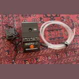 Černý kytarový předzesilovač s nápisy AMPLIFIER TALBOX, BANSHEE 2 a ROCKRON TECHNOLOGY FOR GUITARISTS. Zařízení má několik ovládacích knoflíků, přepí…