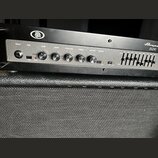 Černý basový zesilovač s nápisy Ampeg a B2R. Přední panel obsahuje vstup INPUT, přepínač PAD, čtyři otočné ovladače s popisky GAIN, BASS, ULTRA MID a…