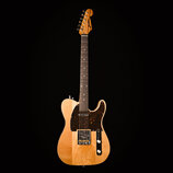 Elektrická kytara s přírodním dřevem těla a hředu. Na hlavě je viditelný nápis „Dunlop“. Kytara má tmavý hrací prkno a tmavě hnědý pickguard s bílými…