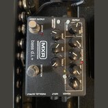 Černý efekt pedál s nápisy MXR, BASSINNOVATIONS a bass d.i.+. Zařízení má dva stomečové spínače označené EFFECT a DISTORTION, pět otočných potenciome…