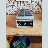 Stříbrný expresní pedál s dvěma šedými plochmi pro nohu. Na zadní straně je nápis BOSS FV-500H a tři konektory označené jako INPUT, OUTPUT a EXP. Pov…