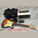 Sada obsahuje elektrickou kytaru s tělem v barvě sunburst, bílým pickguardem a hnědým hmatníkem. Na hlavě kytary je nápis Squier by Fender. Součástí…