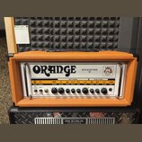 Kytarový zesilovač v oranžovém vinylu s bílým předním panelem. Na panelu je velký nápis ORANGE a modelové označení ROCKERVERB 50. Zesilovač má ovláda…