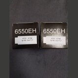 Dvě černé papírové krabičky s bílým nápisem 6550EH. Na každé krabičce je nalepený bílý štítek s textem 6550 / KT88 Ip=80 Gm=7,7. Povrch krabiček je m…