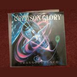 Fotografie zobrazuje obal vinylové desky s nápisem CRIMSON GLORY v horní části a TRANSCENDENCE v dolní části. Na obalu je surrealistický obraz ženské…