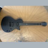 Černá elektrická kytara s matným povrchem a dvěma humbuckery. Na hlavě hředu je bílý nápis "Yamaha". Hриф obsahuje jeden viditelný znak vtíraný do hm…