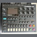 Černý polyfonní digitální syntetizátor s nápisem Digitone a logem elektron. Přístroj obsahuje displej, několik otočných knoflíků označených písmeny A…