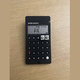 Černý přenosný syntezátor s nápisem pocket operator. Displej zobrazuje grafiku dvou postav, text K.O! a označení PO6. Zařízení má numerickou klávesni…