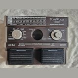 Hnědý efektový procesor s nápisy ToneWorks KORG a MODELING SIGNAL PROCESSOR. Zařízení má dvě šlapadla, dva otočné ovladače a tabulku efektů v horní č…